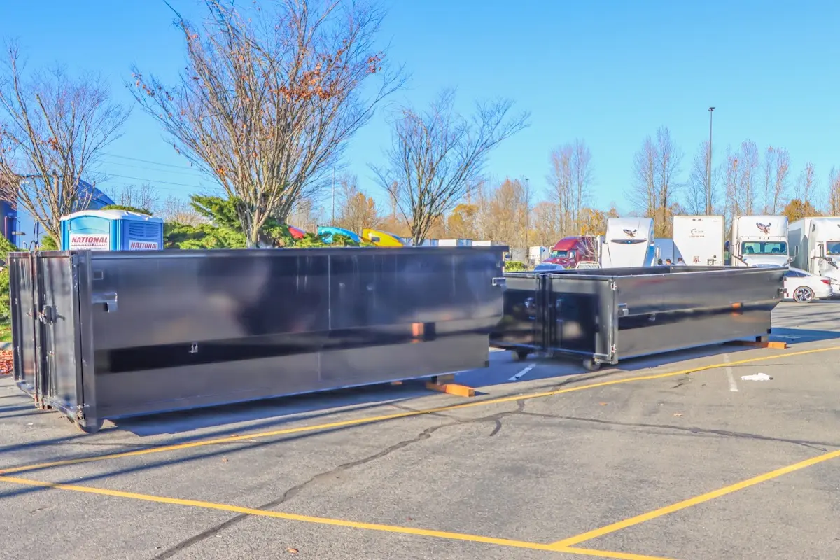 Professional dumpster rental service with roll-off container on residential driveway in Anderson